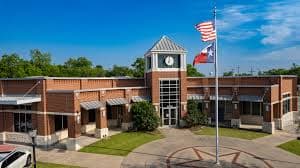 Crew members finishing a commercial concrete pour in Commerce, TX.
