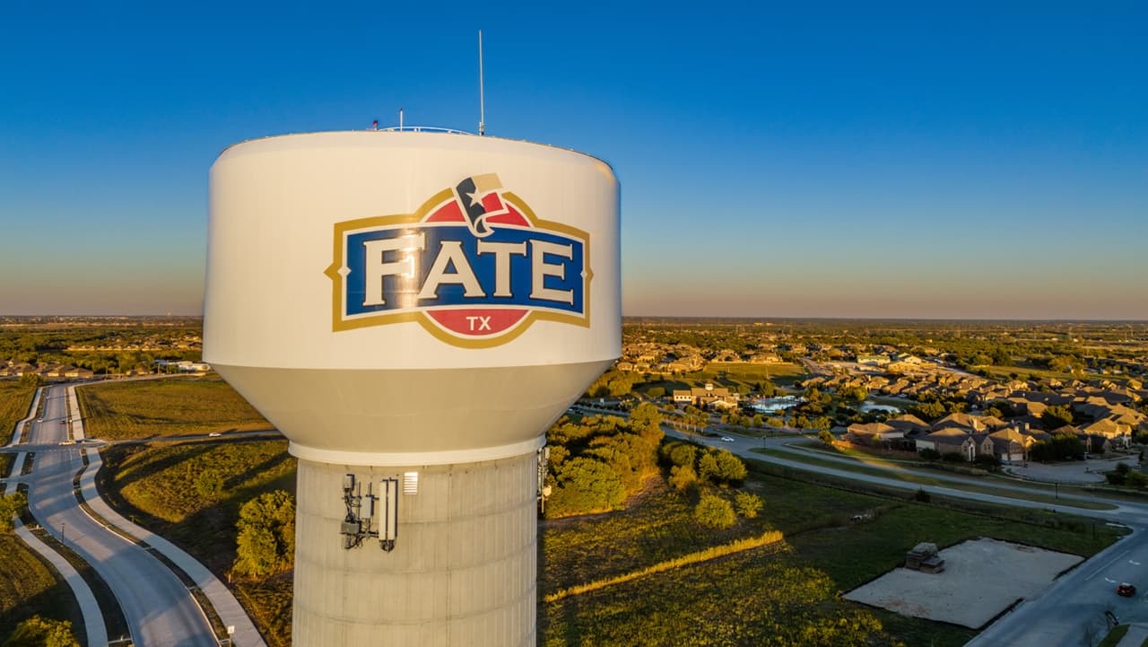 Crew members finishing a commercial concrete pour in Fate, TX.